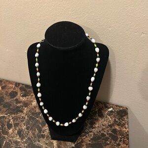 Red, green, yellow, and black beaded necklace with White shell beads